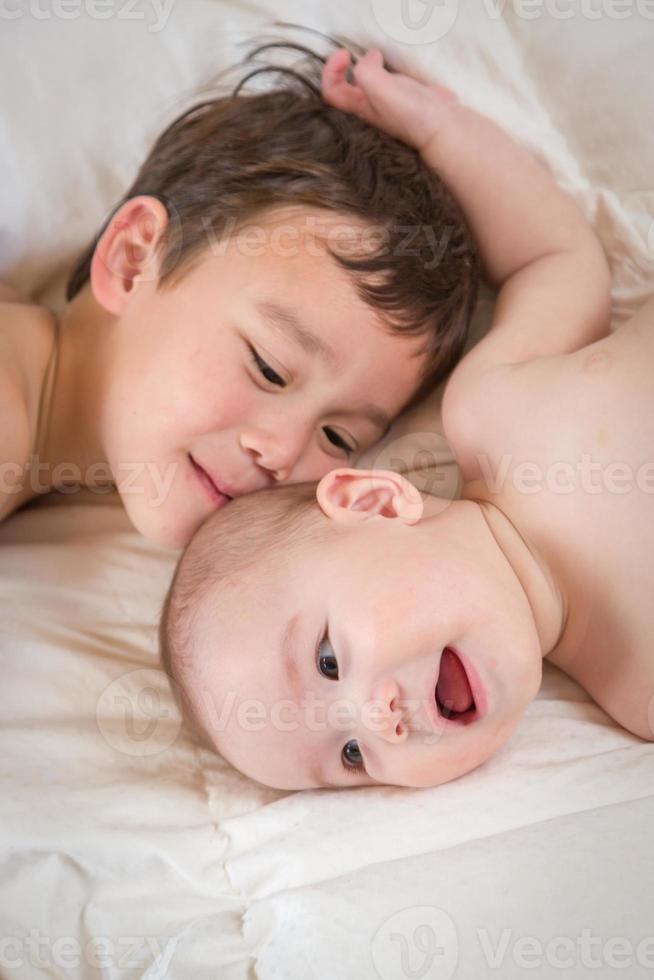 Mixed Race Chinese and Caucasian Baby Brothers Having Fun Laying on Their Blanket photo