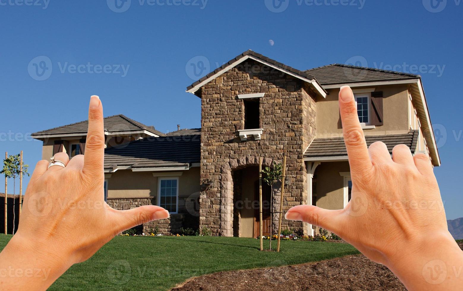 Female Hands Framing Beautiful House photo