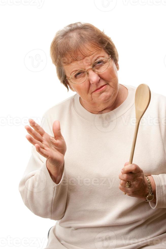 Upset Senior Woman with The Wooden Spoon photo