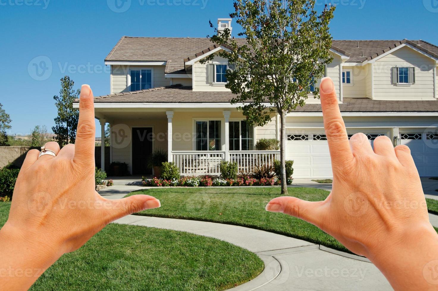 Female Hands Framing Beautiful House photo