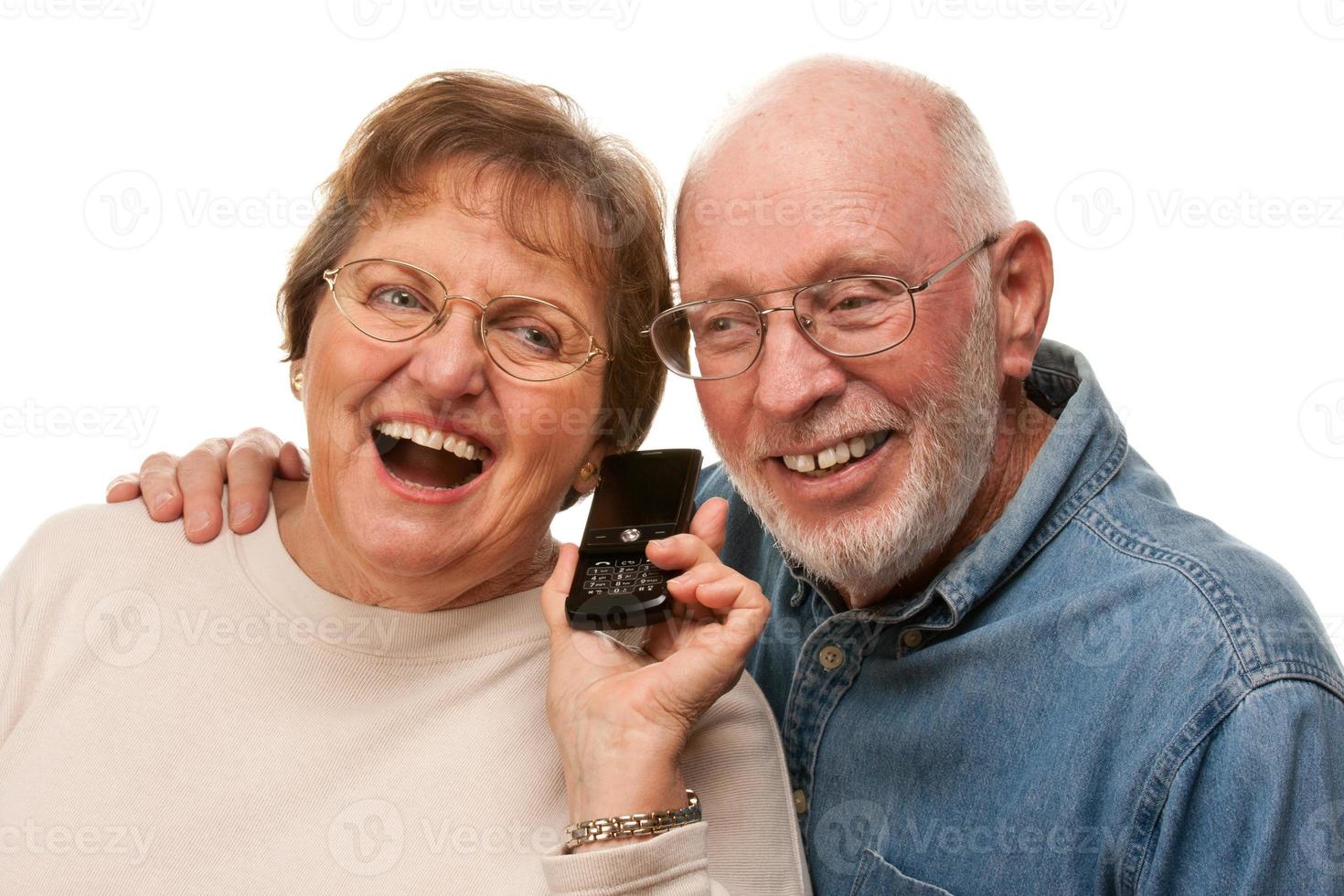 Happy Senior Couple Using Cell Phone on White photo