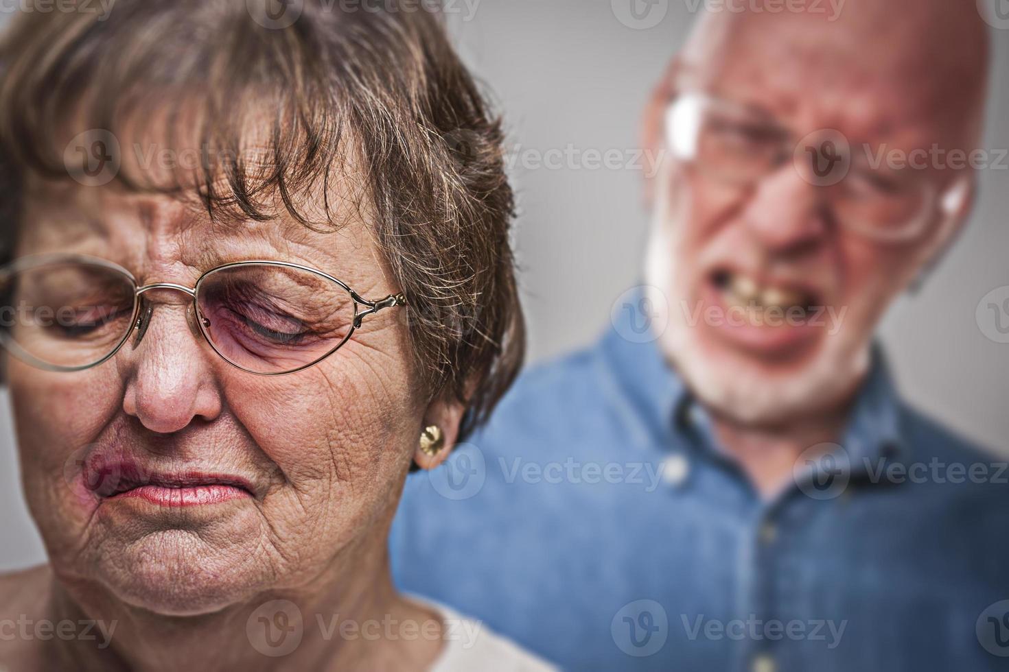 Battered and Scared Woman with Ominous Man Behind photo