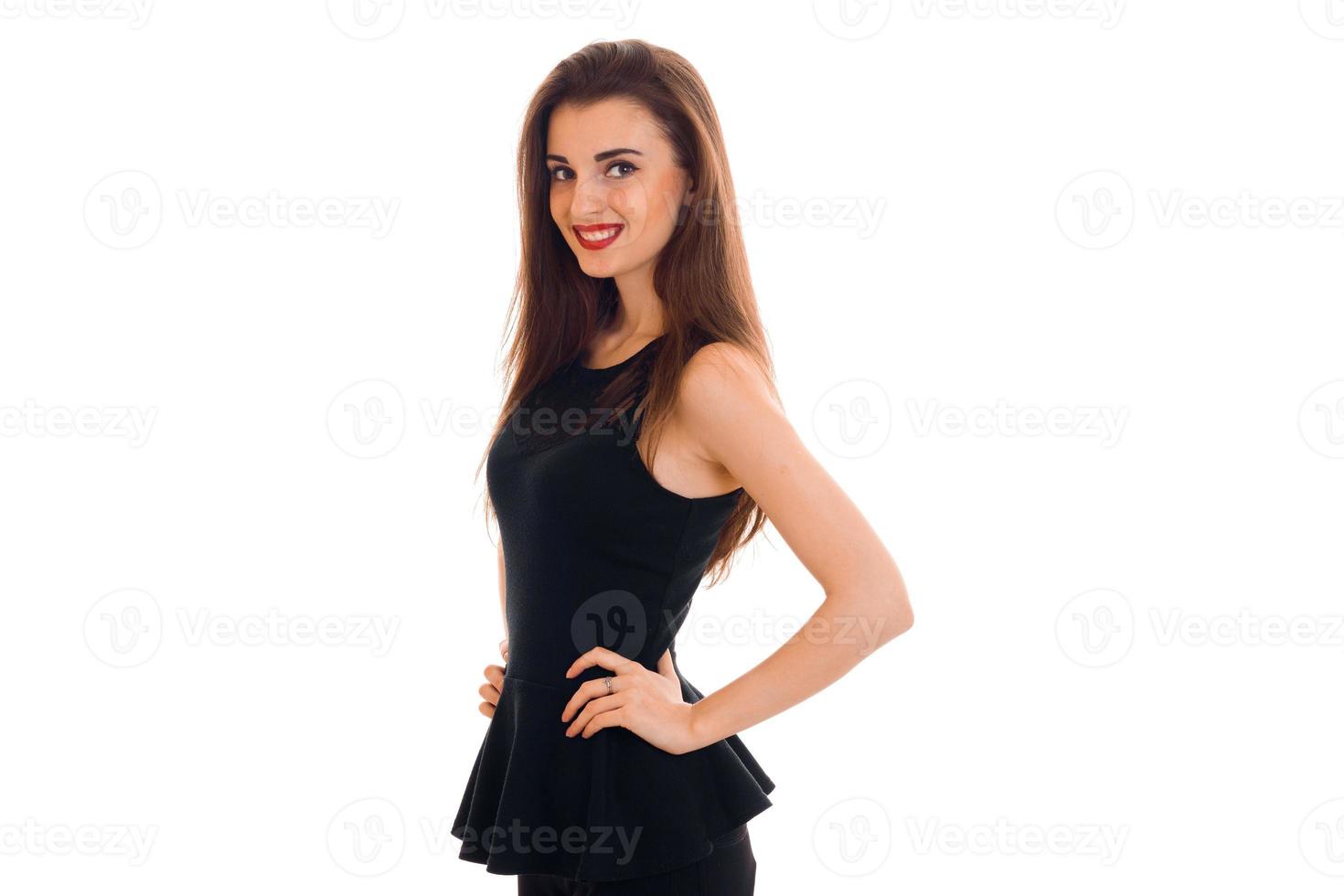 cheerful young lady with red lips in black dress looking at the camera and smiling isolated on white background photo