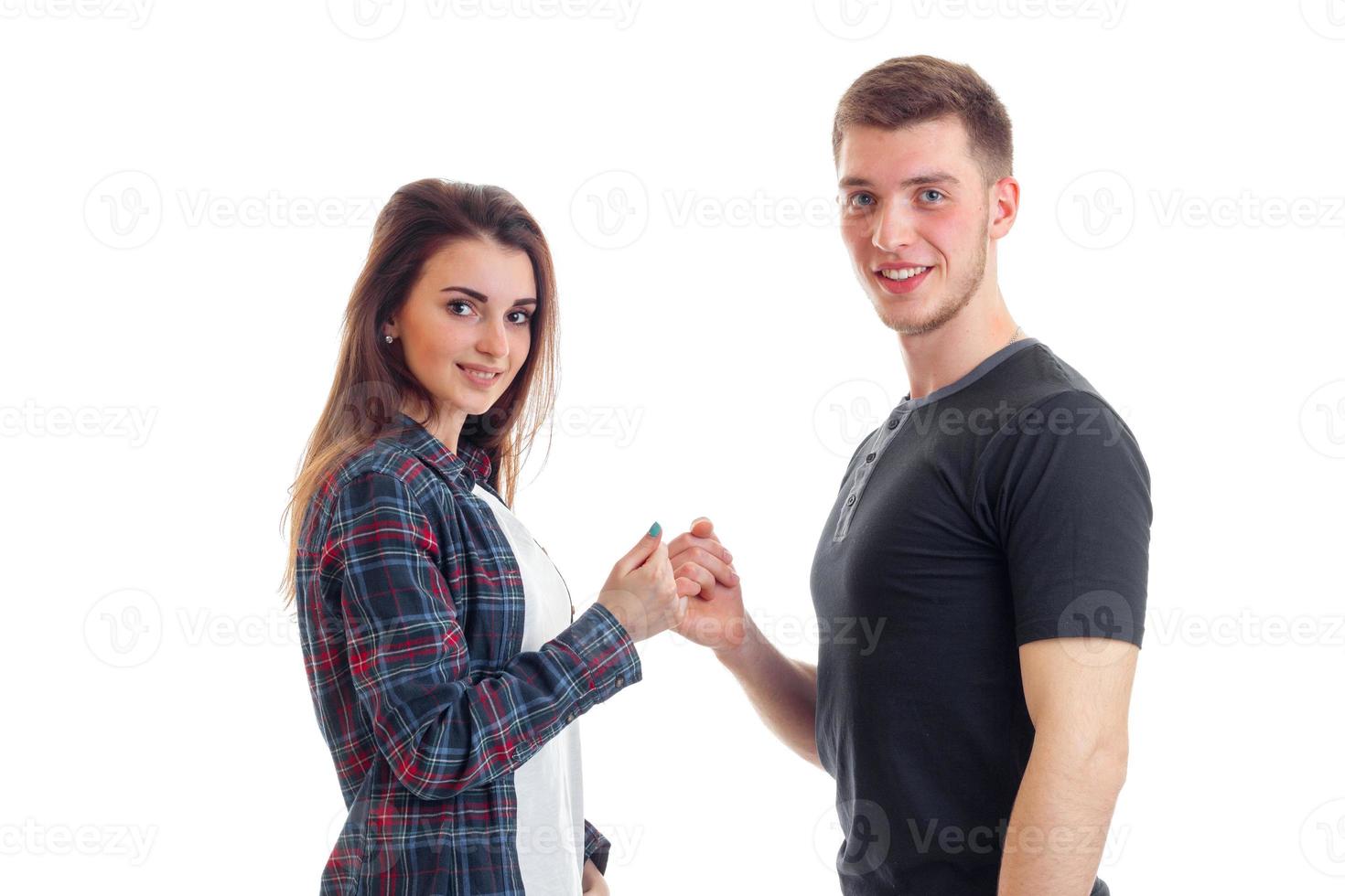 beautiful smiling girl and a young gay guy hold each other for little fingers close-up photo
