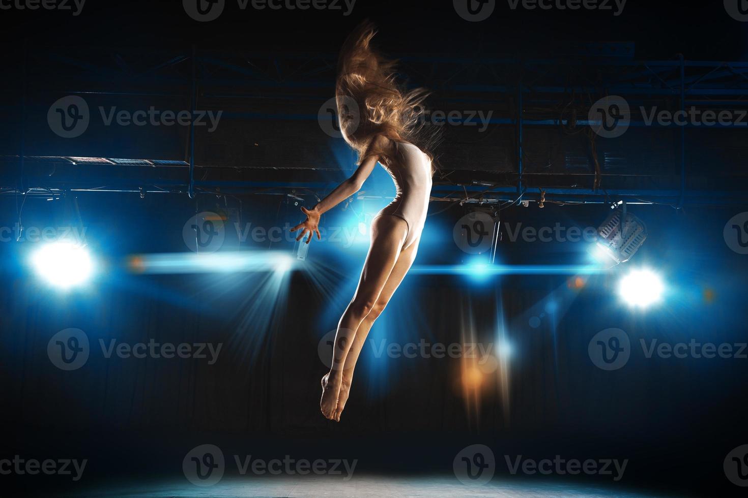 Ballet dancer fly on stage in theater photo