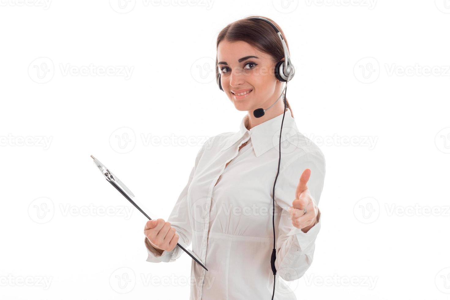 portrait of cheerful brunette call center worker girl with headphones and microphone isolated on white background photo