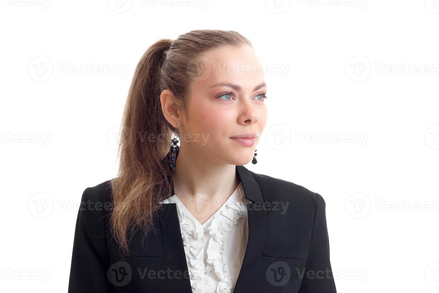 Portrait of chic young blonde with a ponytail and a jacket that looks toward close-up photo