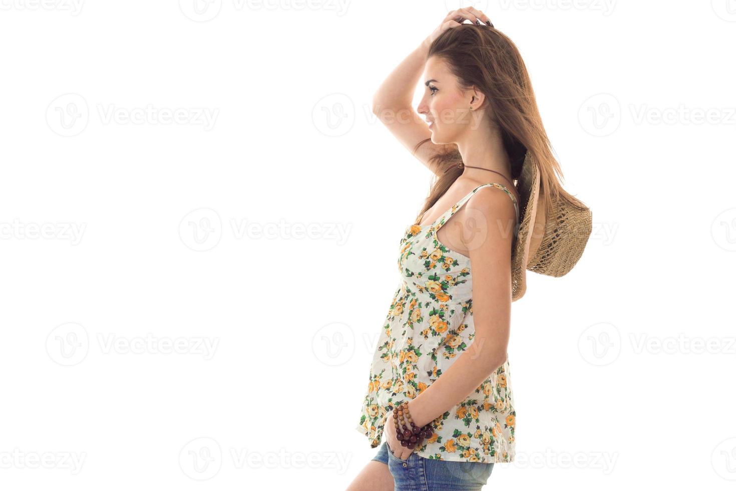 portrait of beautiful young brunette woman in sarafan with floral pattern posing isolated on white background photo
