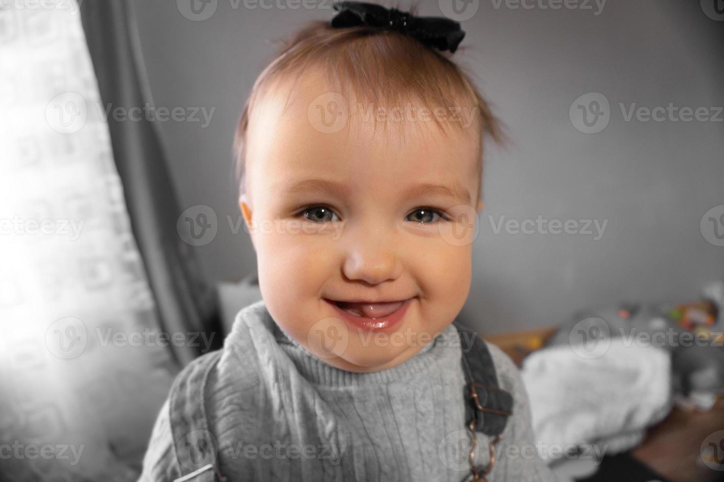 Cutie little baby girl smiles at home photo