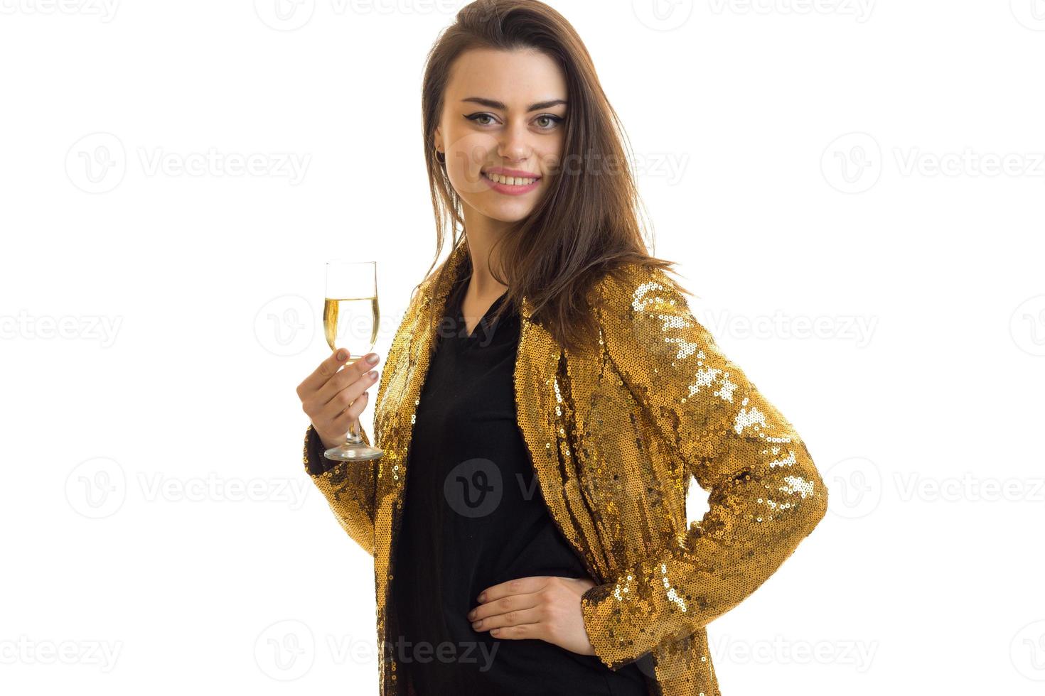 Cheerful lady in golden jacket with wine smiles photo