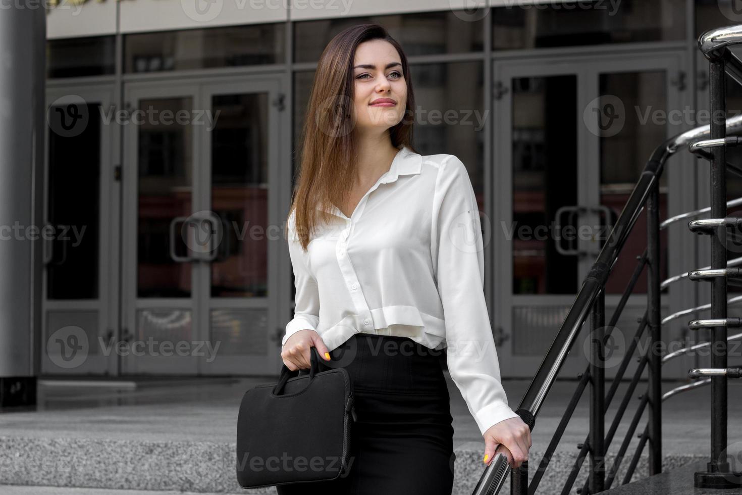 a charming young girl in a white business shirt smiling photo