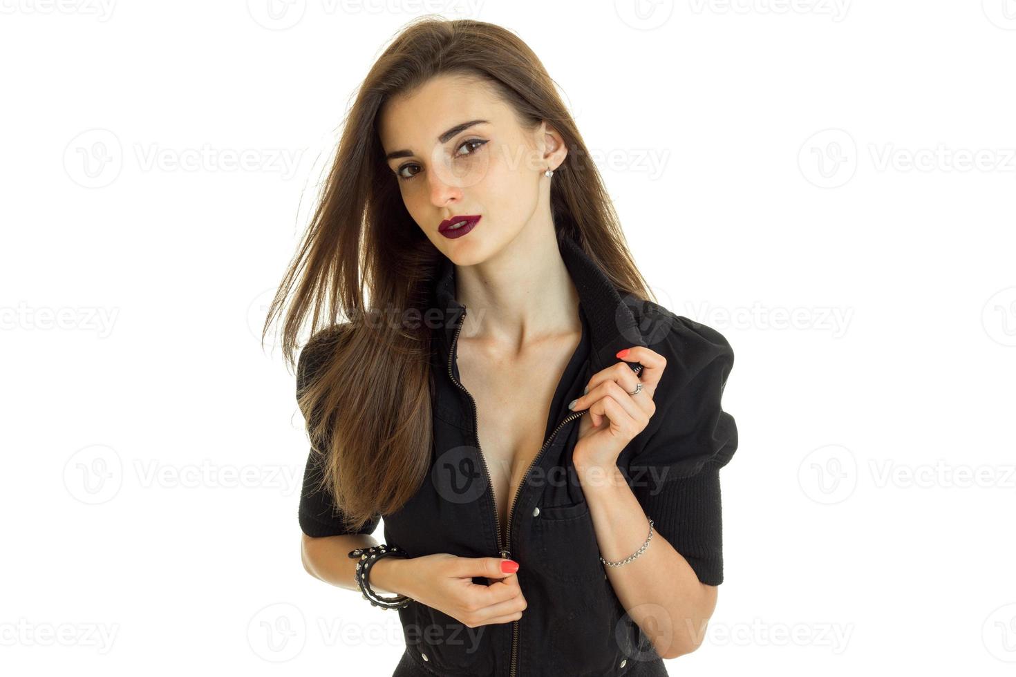 Seductive woman unbuttons a black jacket on camera photo