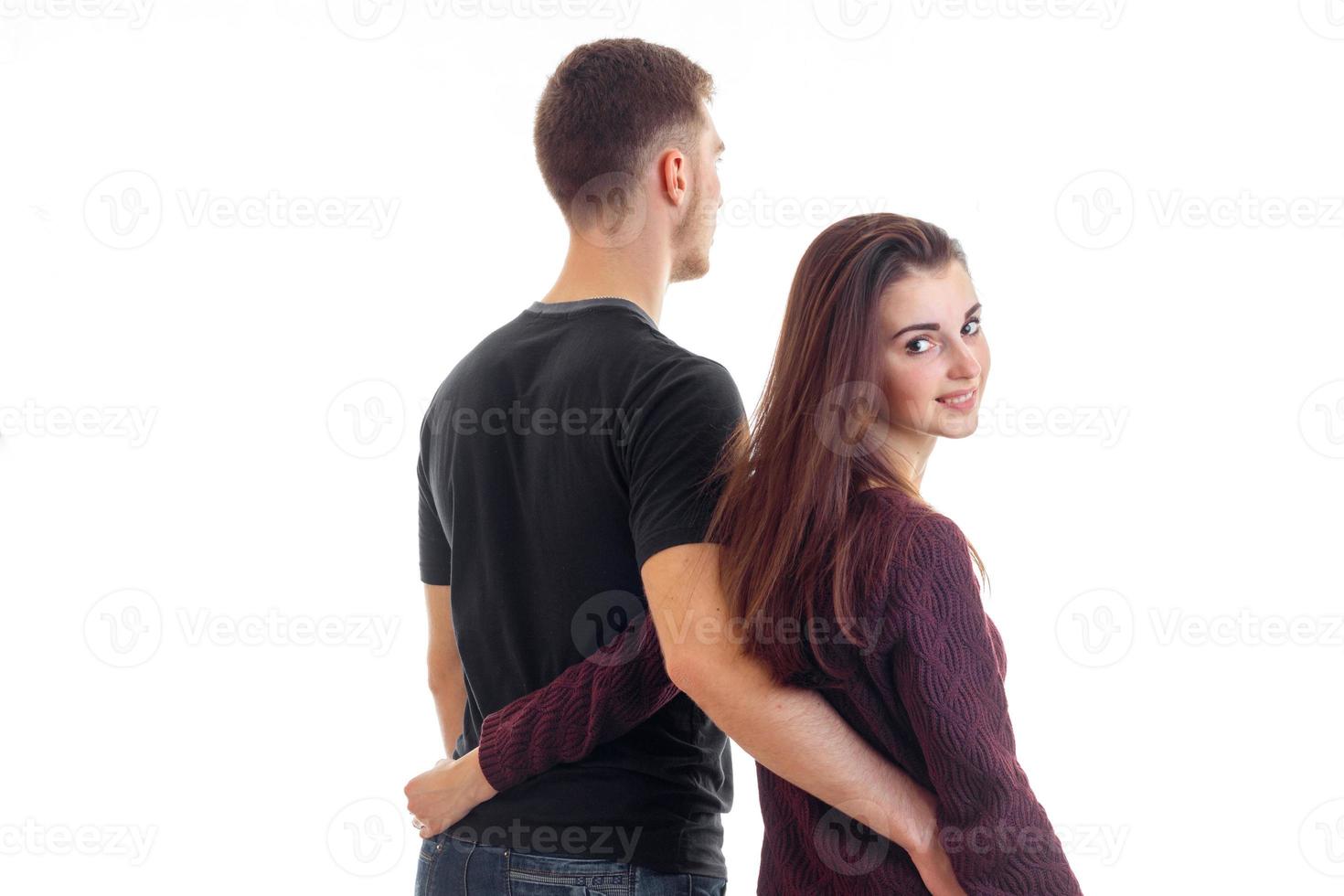 Cute young couple hugging and smiling in studio photo