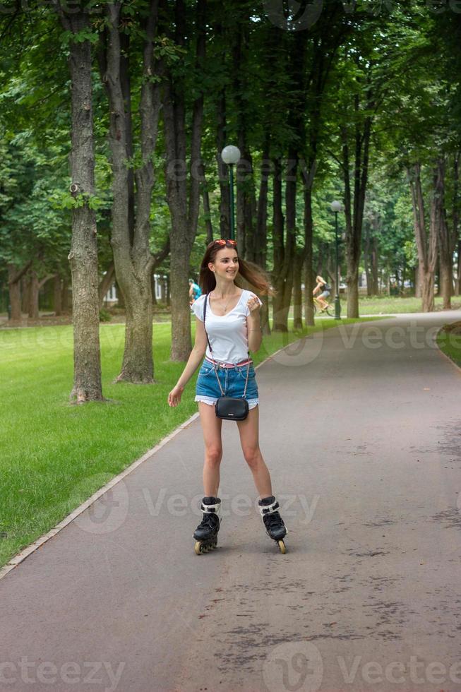 beautiful happy girl in shorts rollerblading in the Park 16460000 Stock