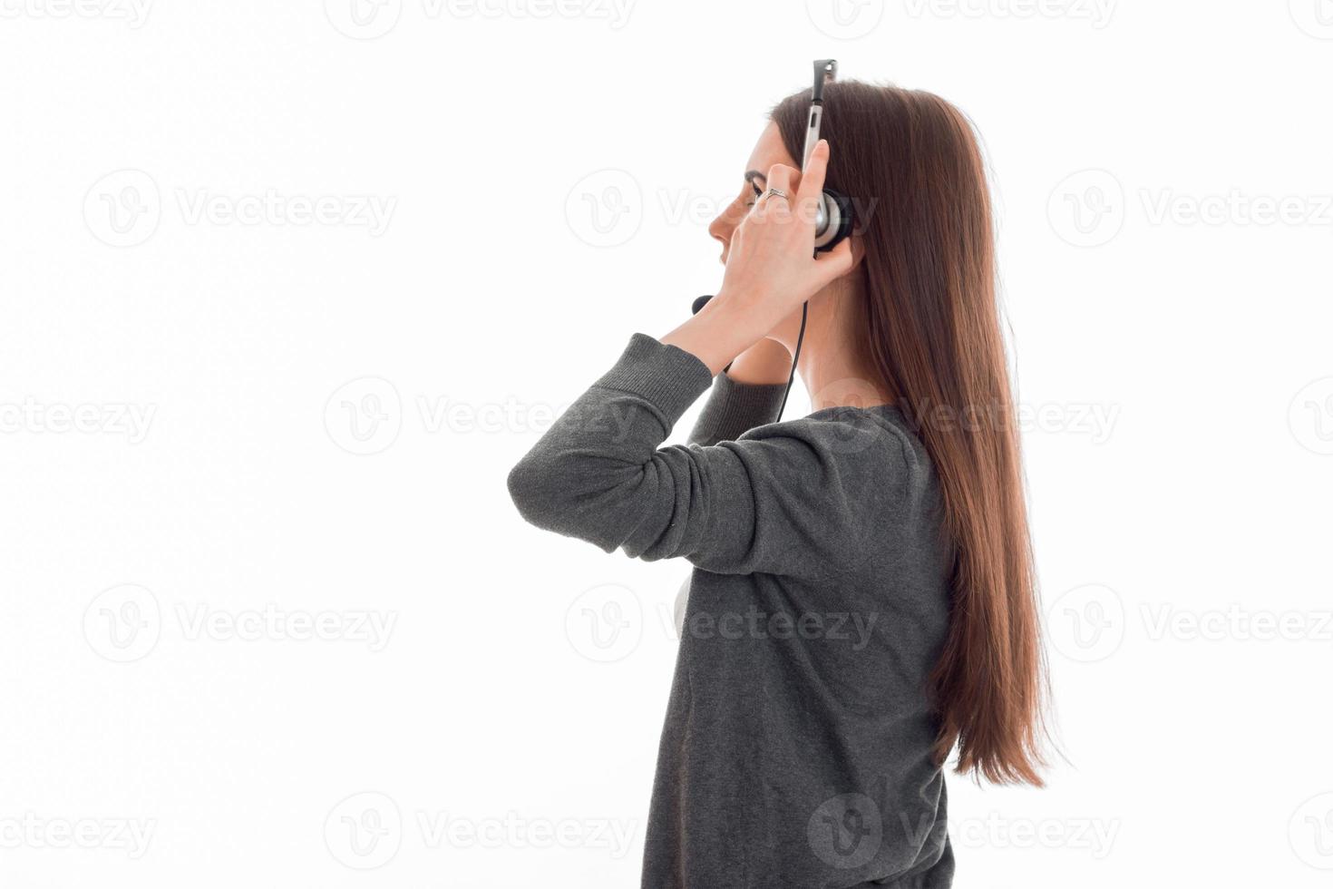 a young girl is worth turning sideways to the camera and listening to headphones photo