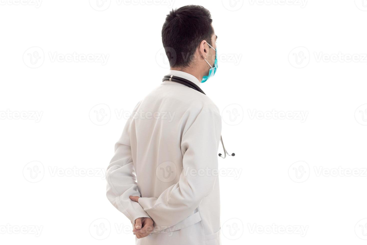 young doctor in blue uniform with stethoscope on his neck isolated on white background photo