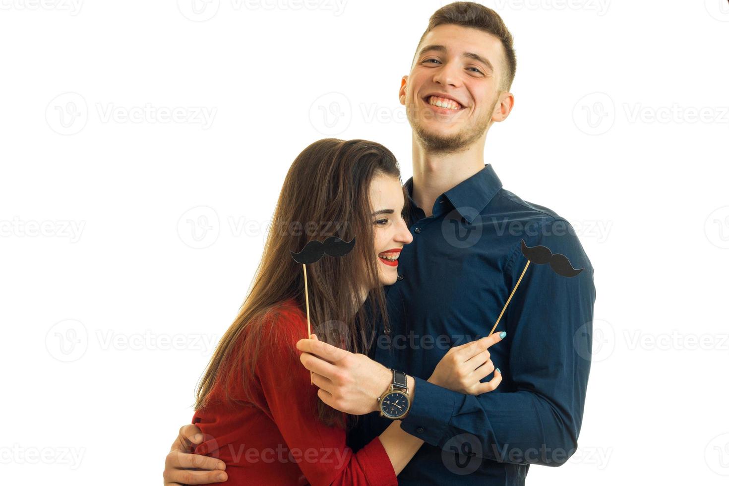 cheerful beautiful young guy with girl, hug each other and laughing photo