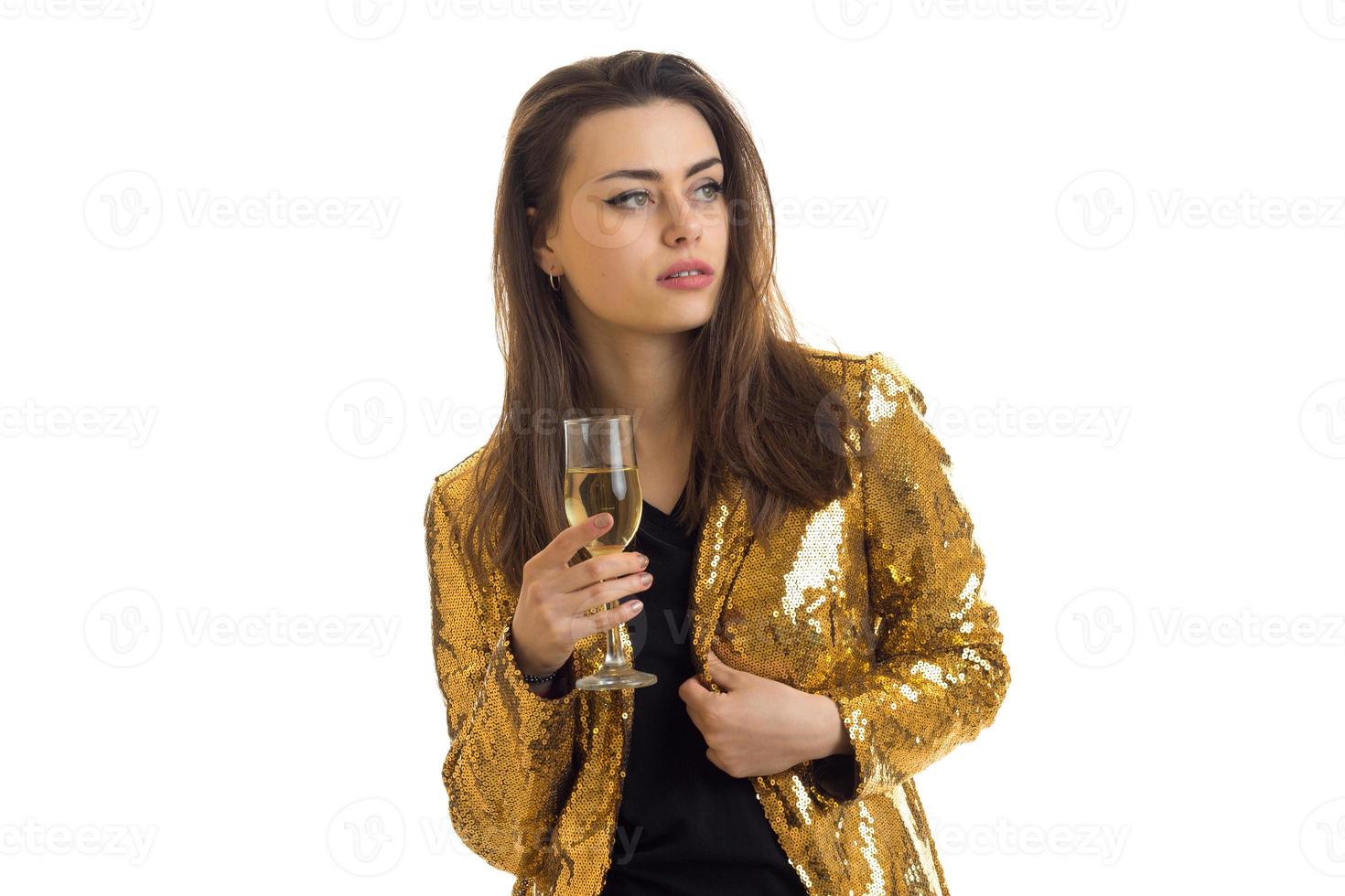 Cute stylish brunette in golden jacket with glasses of wine in hands photo