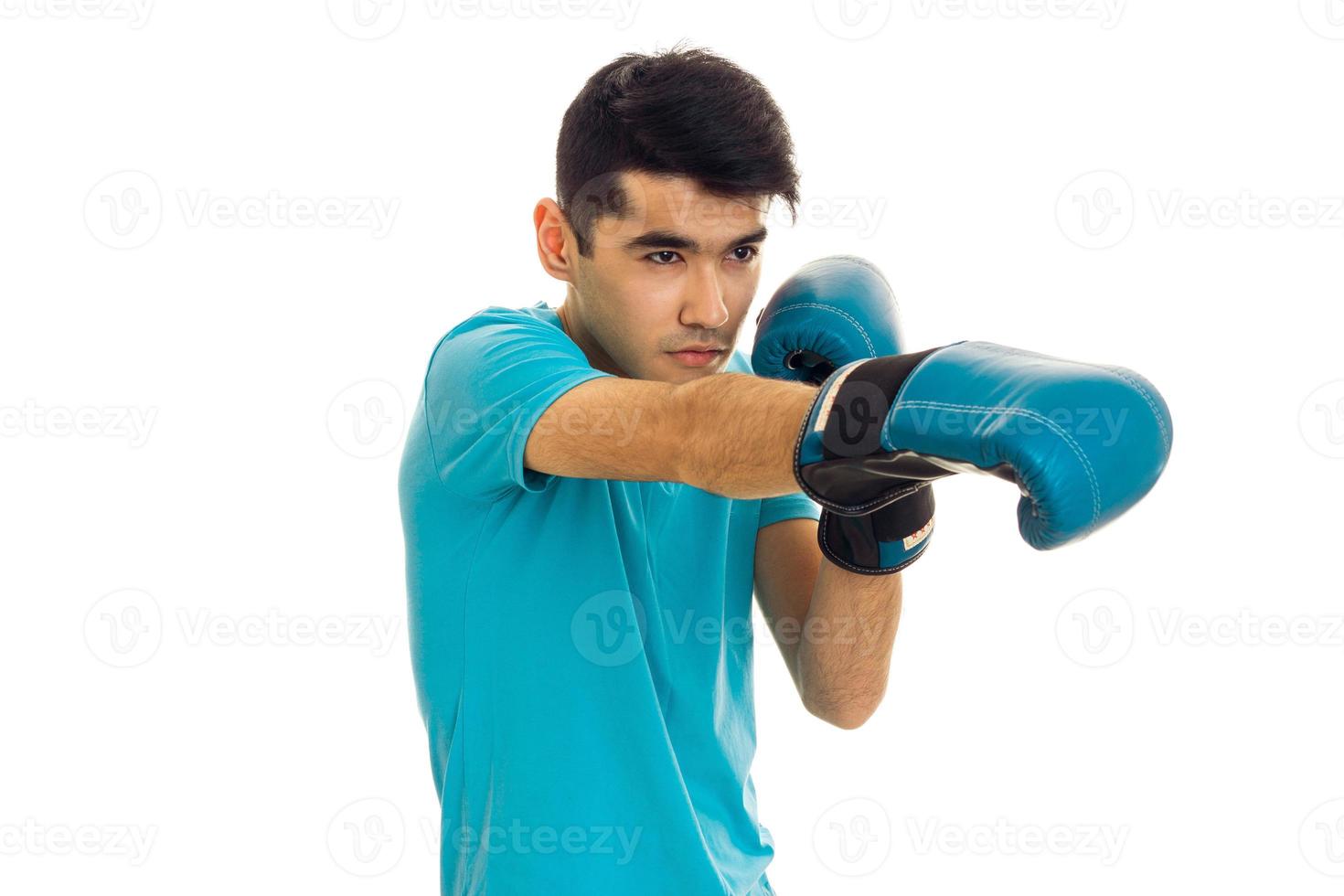 portrait of strong brunette sports man practicing box in blue gloves isolated on white background photo