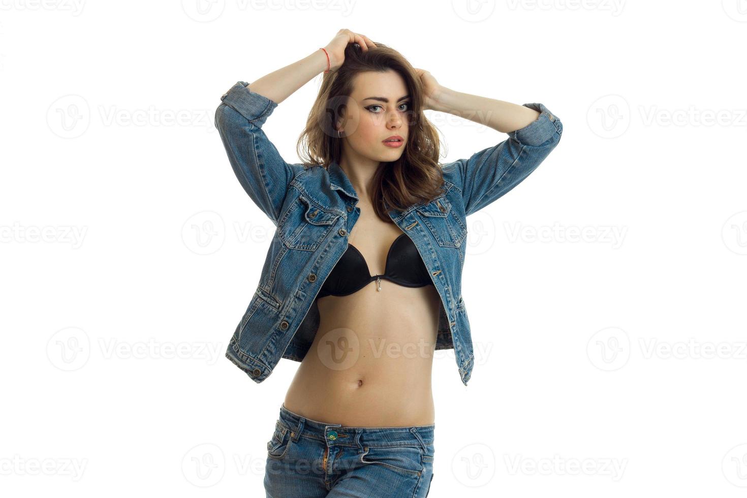 beautiful young girl in Bra and jeans jacket raised her hands to the hair photo
