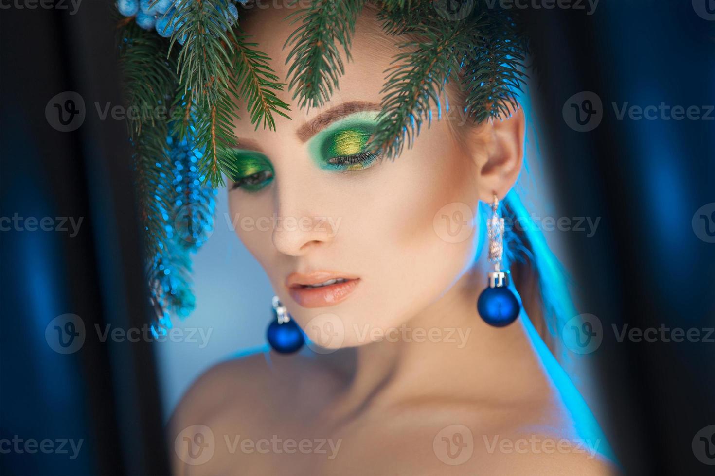 Christmas photo of beautiful girl with wreath on head and healthy skin