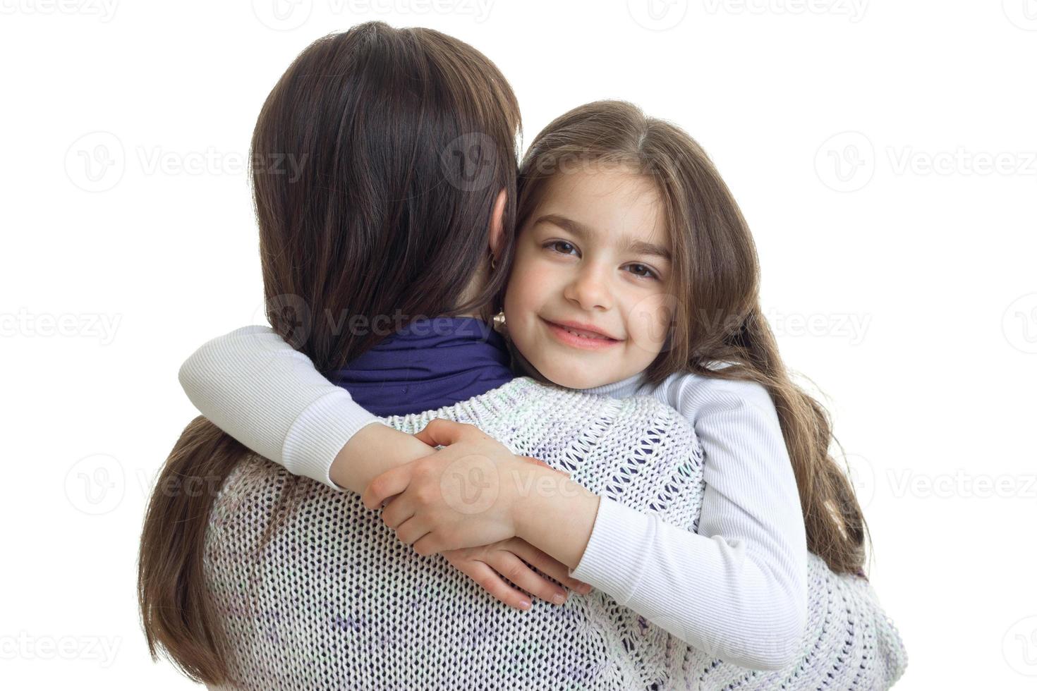 close-up portrait of a little cute girls that hugs her mother photo