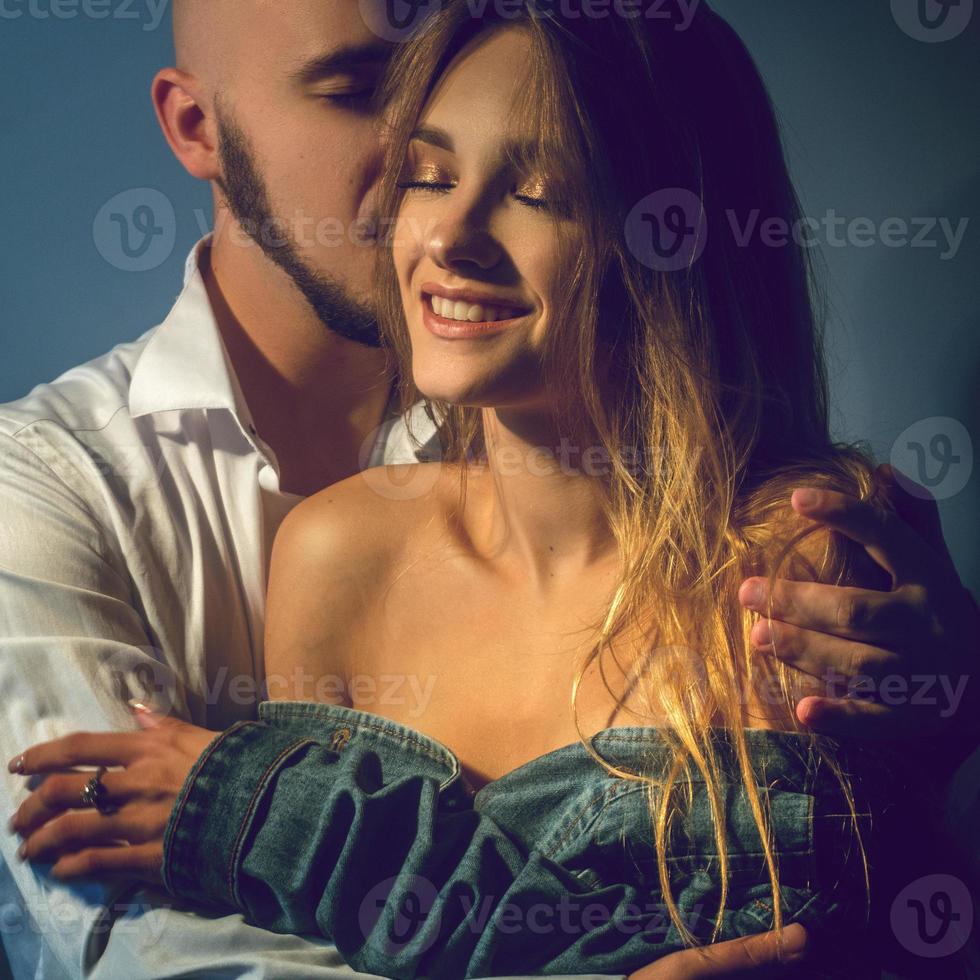 cheerful young couple in love hugs and smiles photo