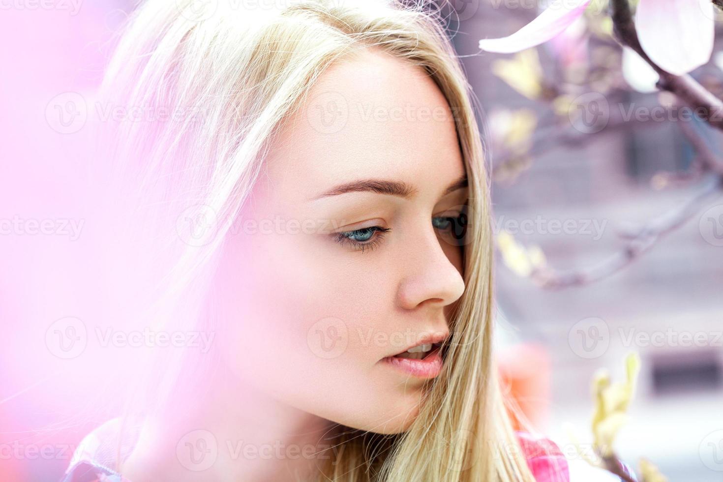 thoughtful young blonde with blue eyes looking away photo