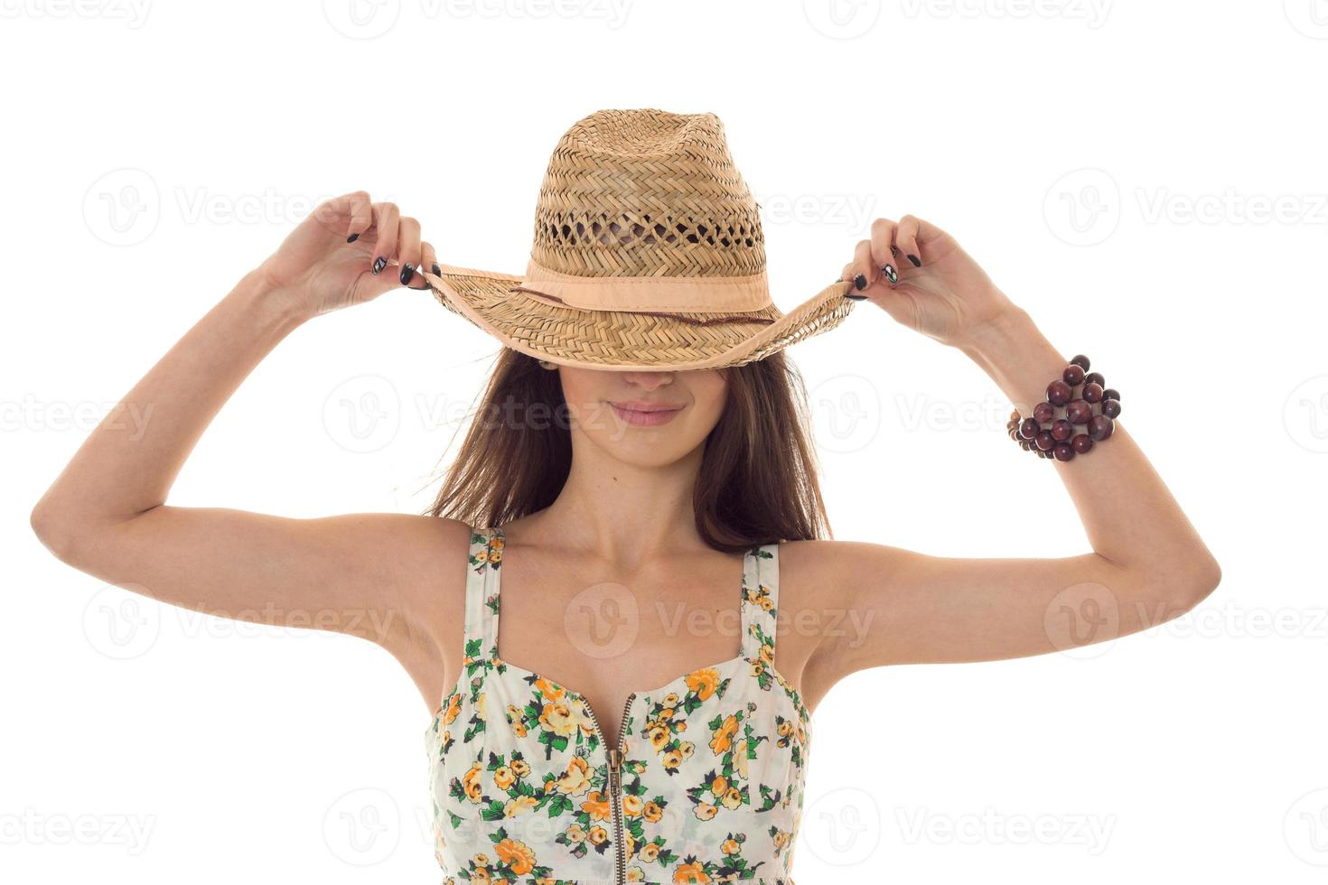 the girl wore a big hat and keeps her hands close-up photo