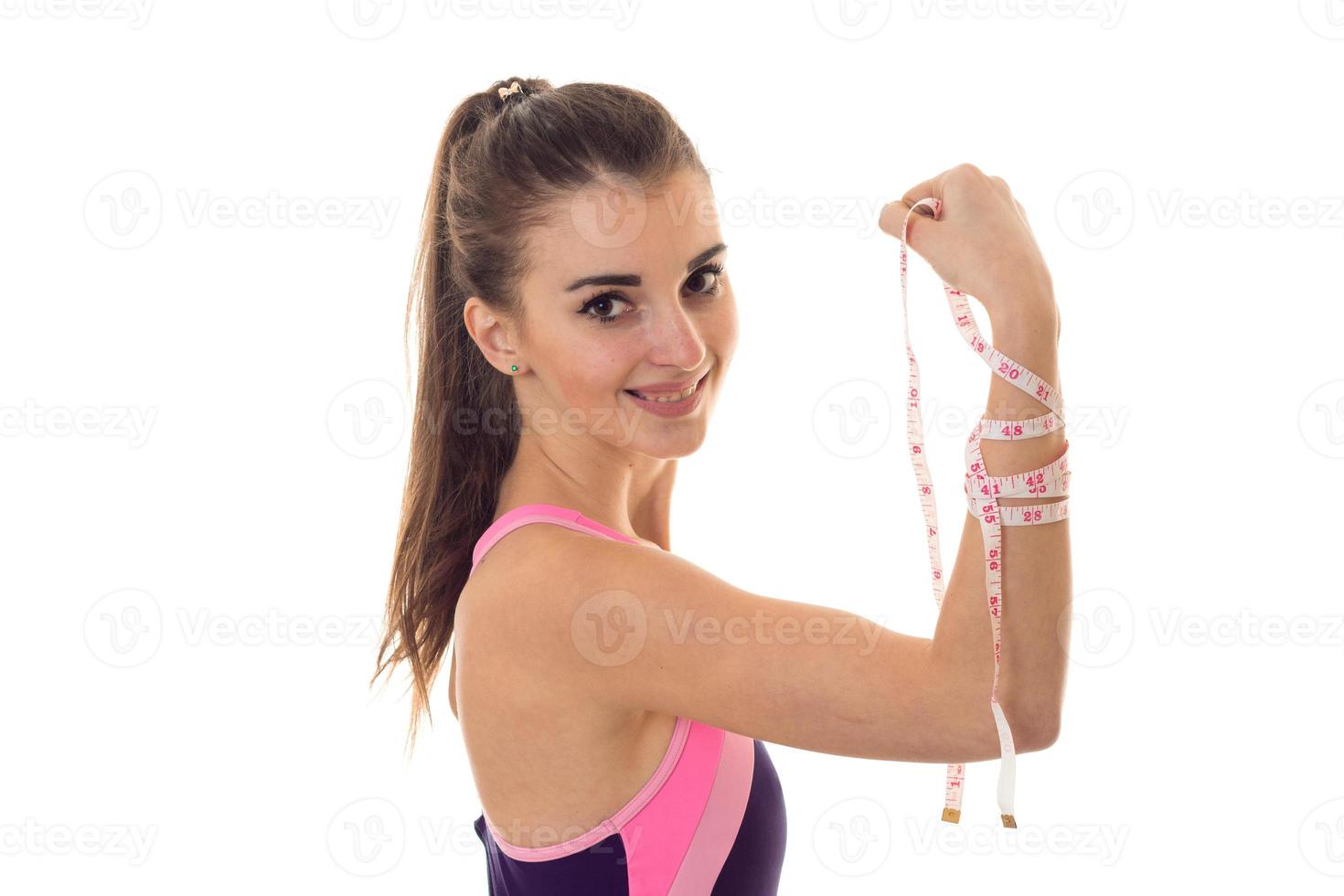 young beautiful lady in body swimsuit with measure tape posing and smiling on camera isolated on white background photo