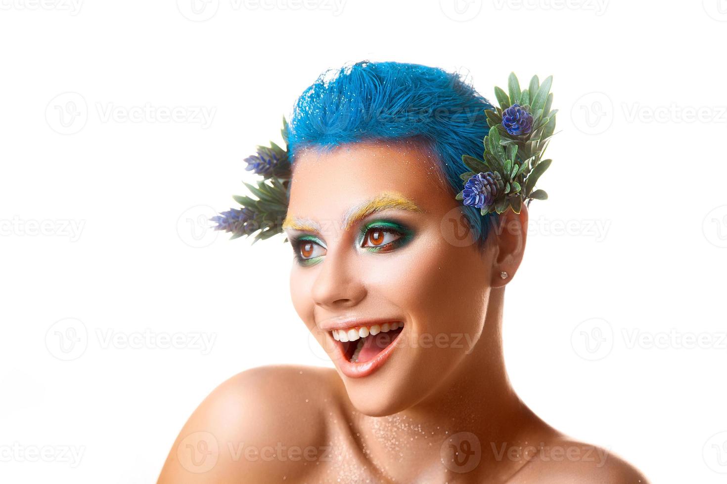 Funny girl with multicolor makeup smiling on white background photo
