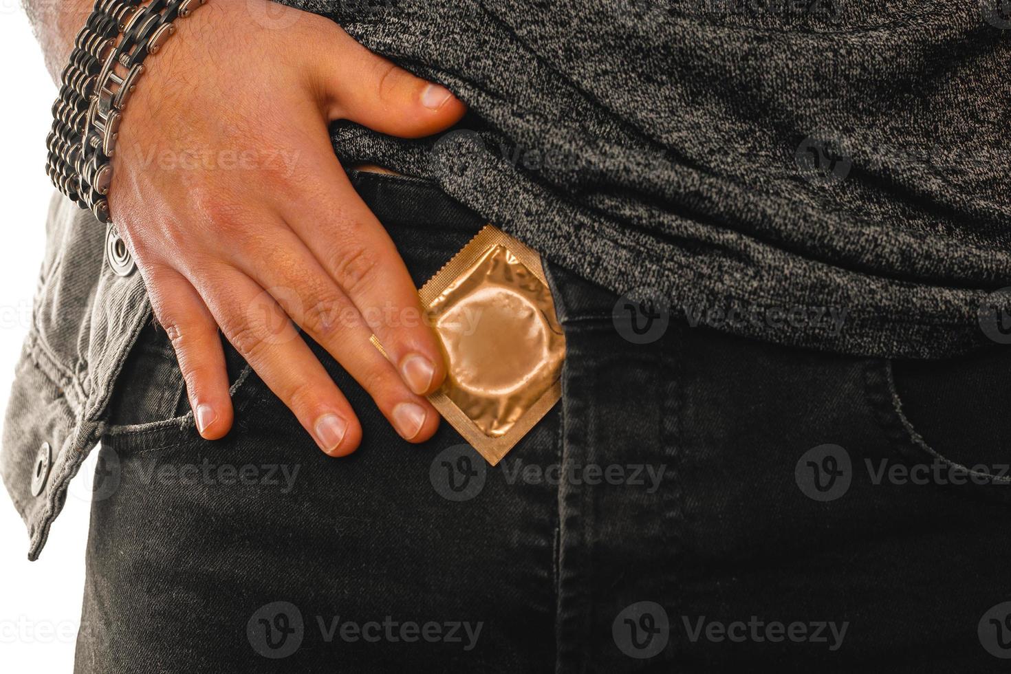 man gets a golden condom out of his pocket photo