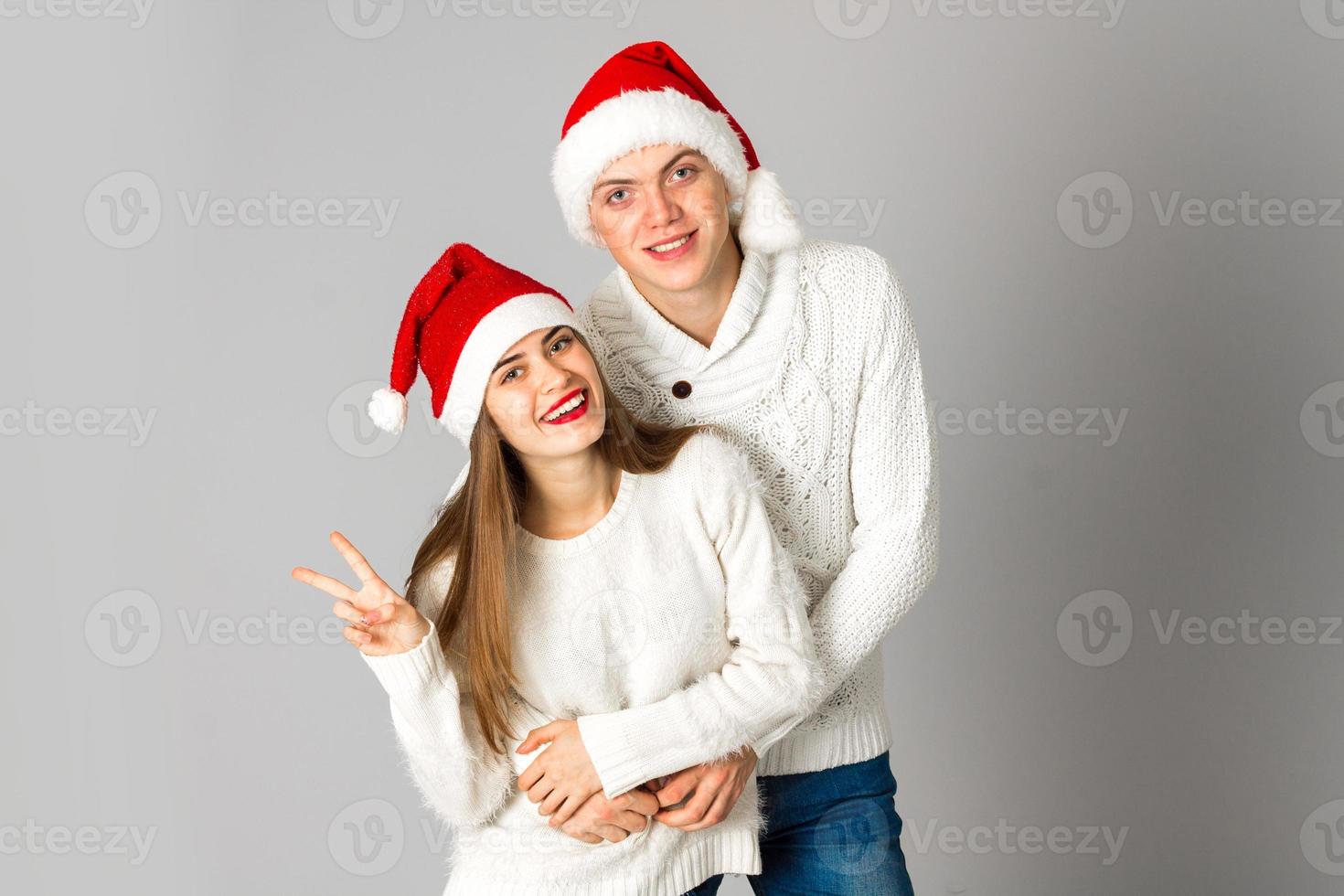 couple in love celebrates christmas in santa hat photo