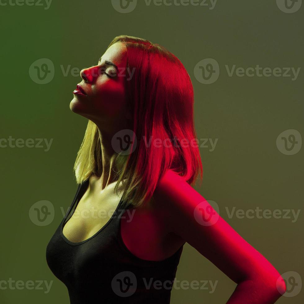 Profile adult caucasian girl with closed eyes on green background photo