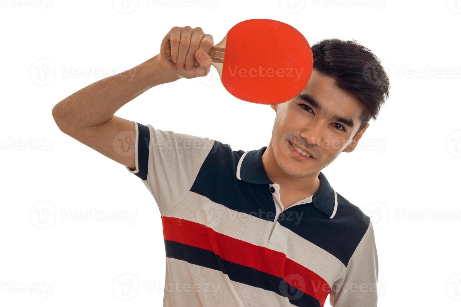 cheerful young brunett sportsman practicing ping-pong isolated on white background photo