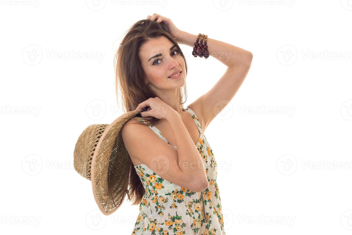 summertime portrait of young charming girl in light clothes with straw hat posing isolated on white background photo