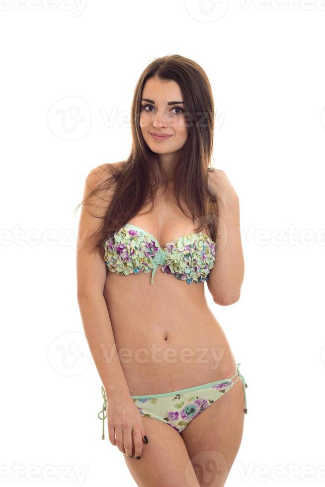 slim sexy brunette girl in swimsuit looking and smiling on camera isolated  white background photo