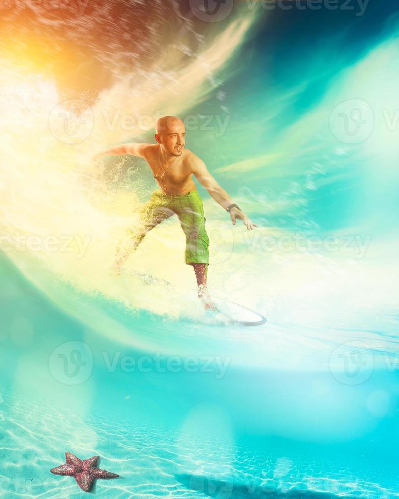 man riding a surfboard on a wave photo