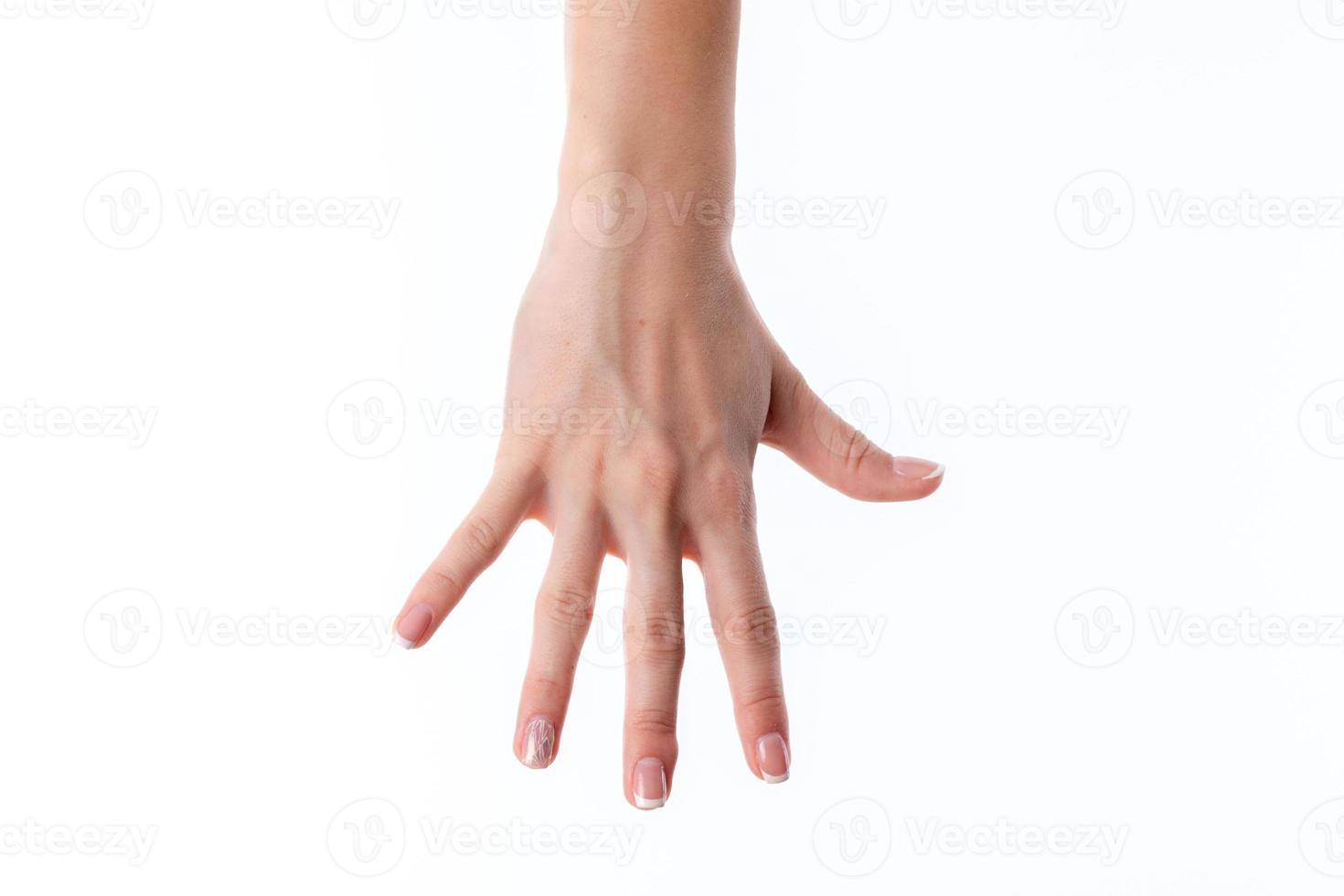 female hand stretched down and showing the five fingers is isolated on a white background photo