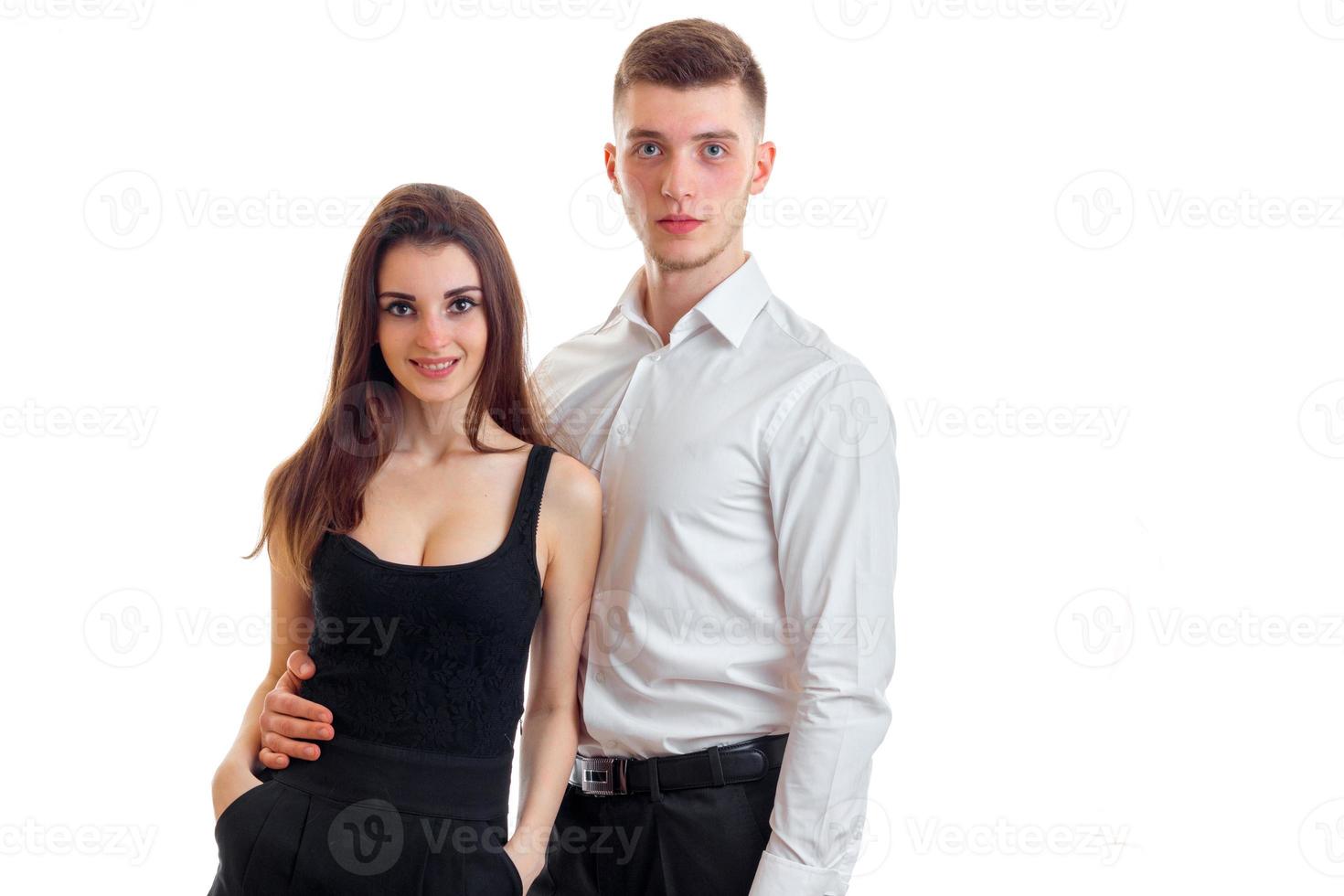 a charming young girl in a black dress next to a handsome guy in a white shirt photo