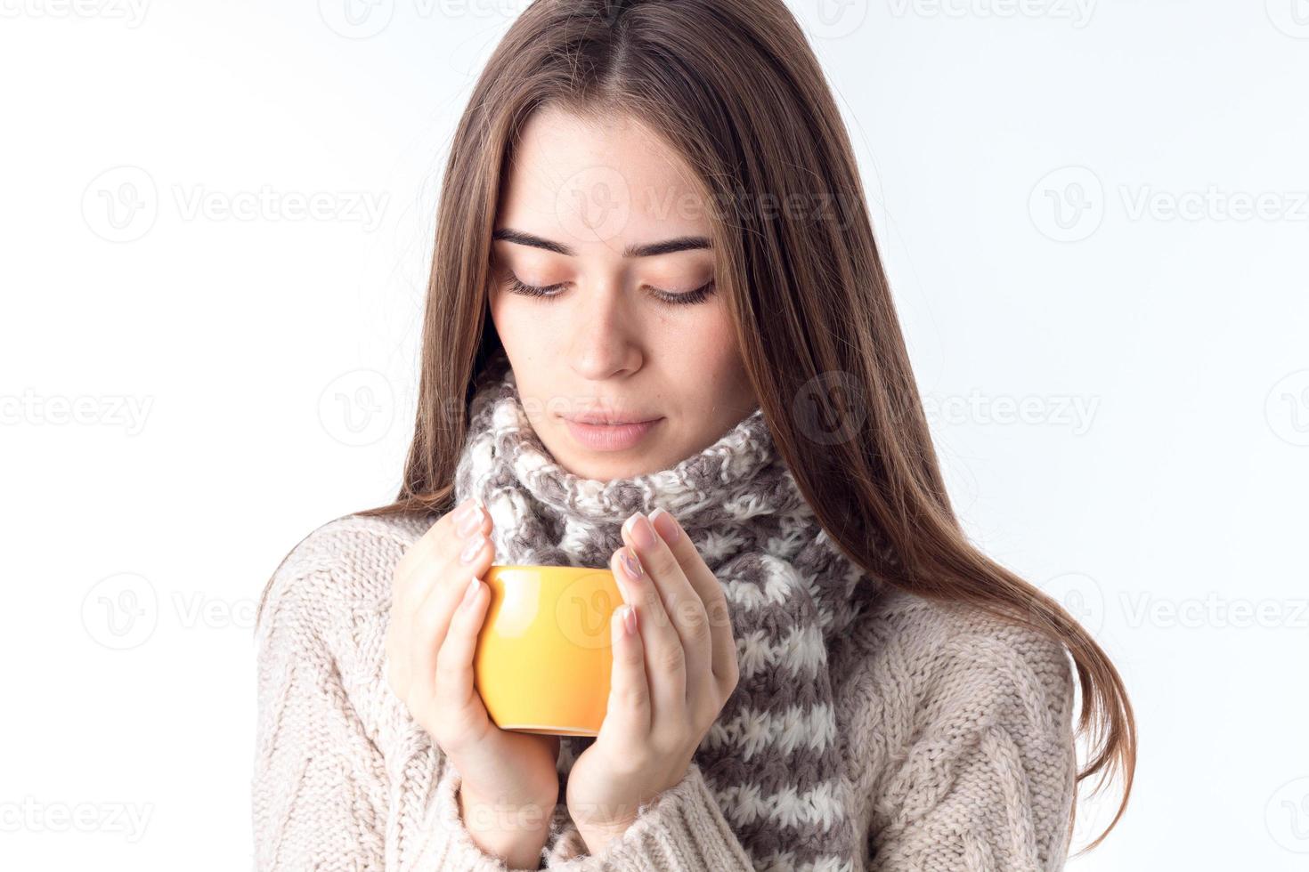 a young girl with  scarf and hot cup in the hands of isolated on white background photo