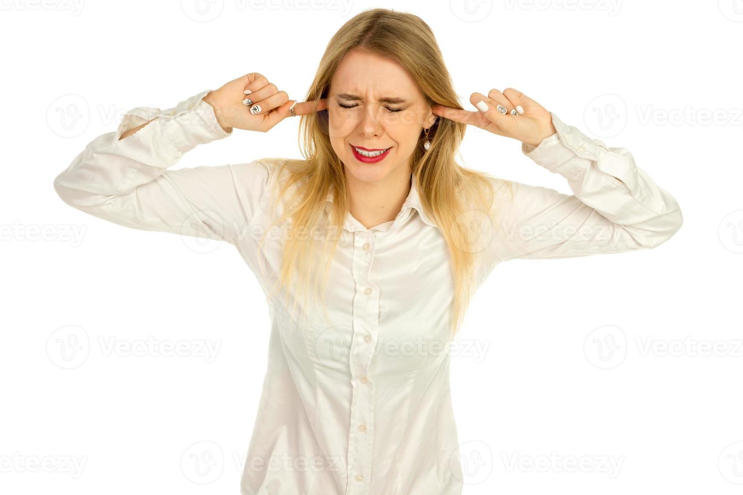 girl covers her ears with her fingers from loud noises photo