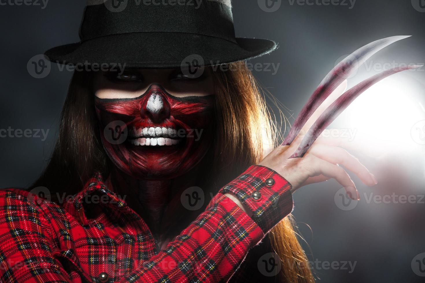 Scary halloween portrait of woman with knifes in hand photo