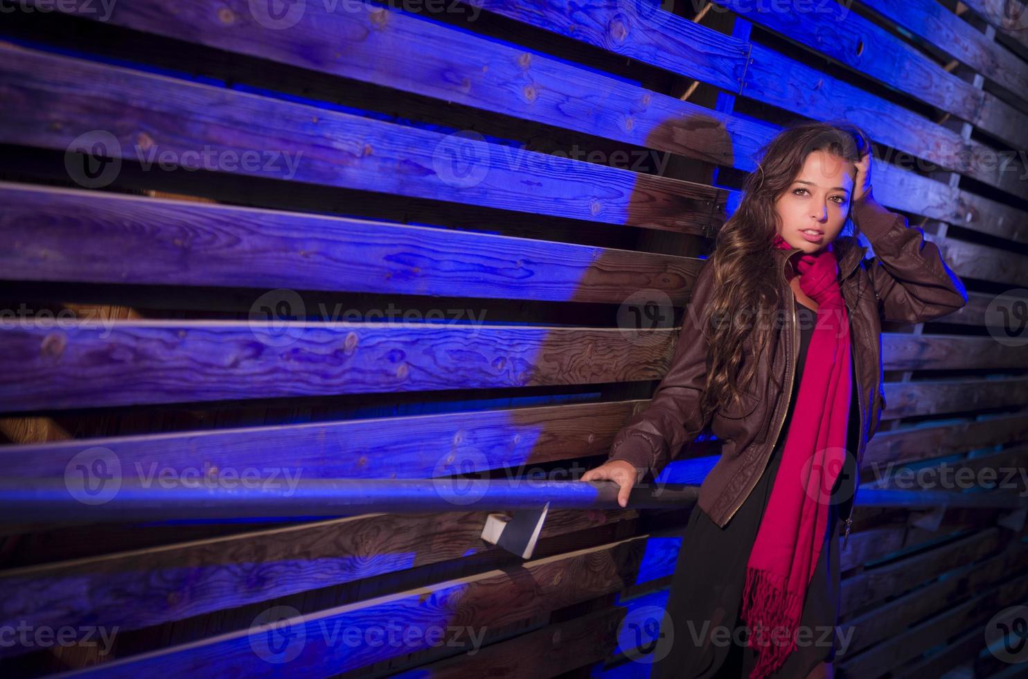 Mixed Race Young Adult Woman Against a Wood Wall Background photo