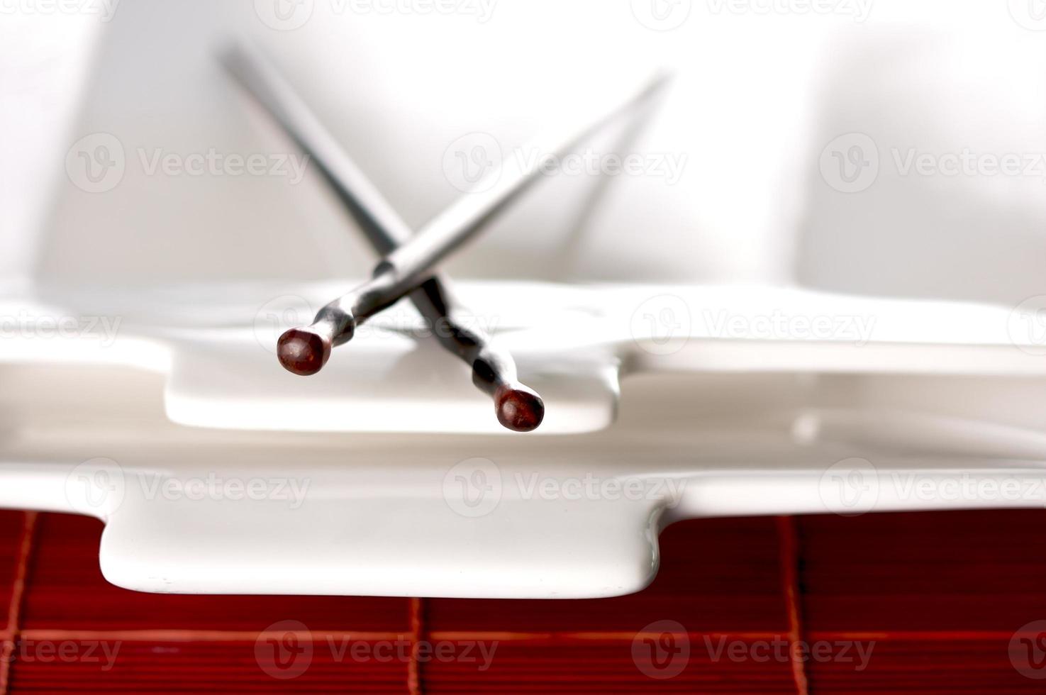 Wooden Chopsticks and White Plate photo