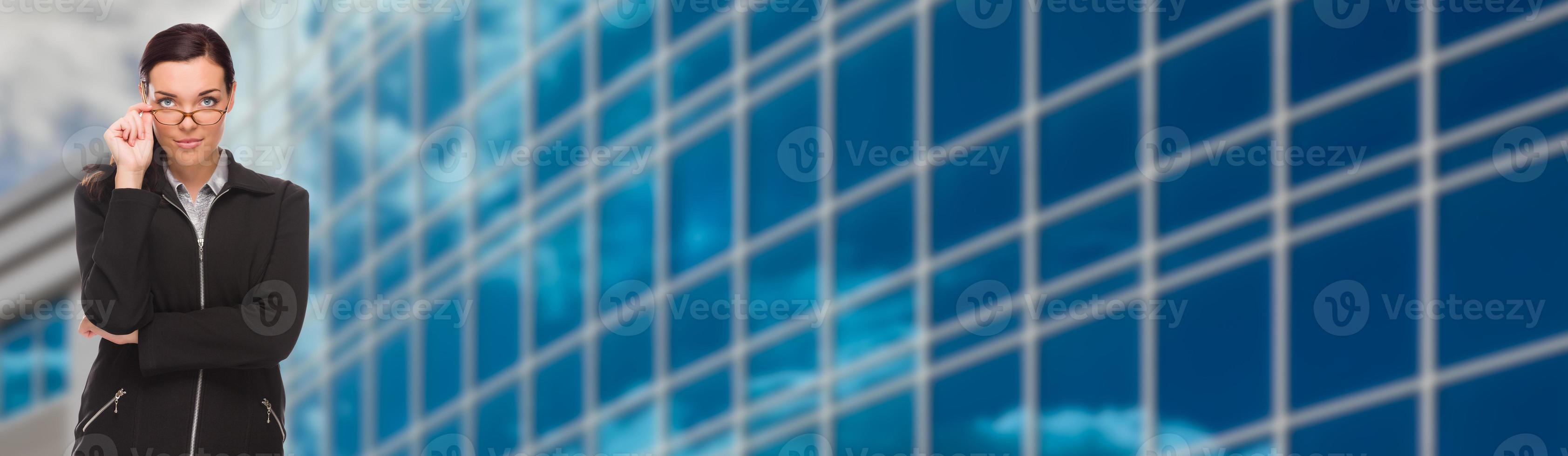 Serious Mixed Race Businesswoman In Front of Corporate Building Banner photo