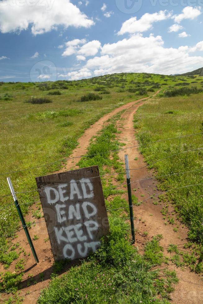 Dead End Keep Out Sign On Wire Fence At Dirt Road photo