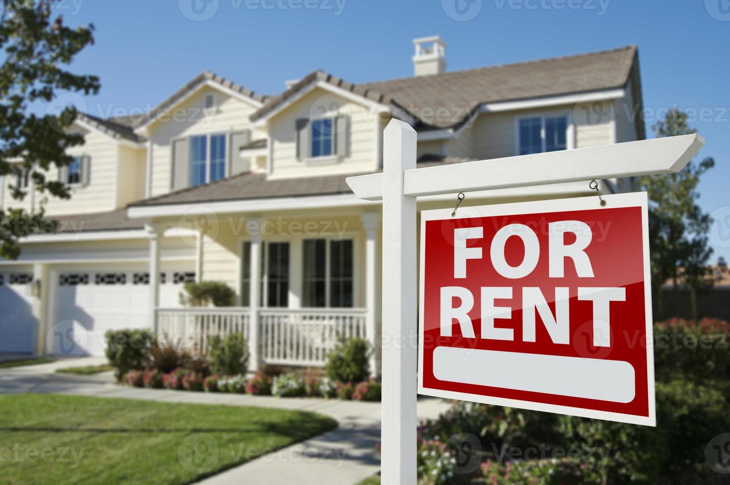 For Rent Real Estate Sign in Front of House photo