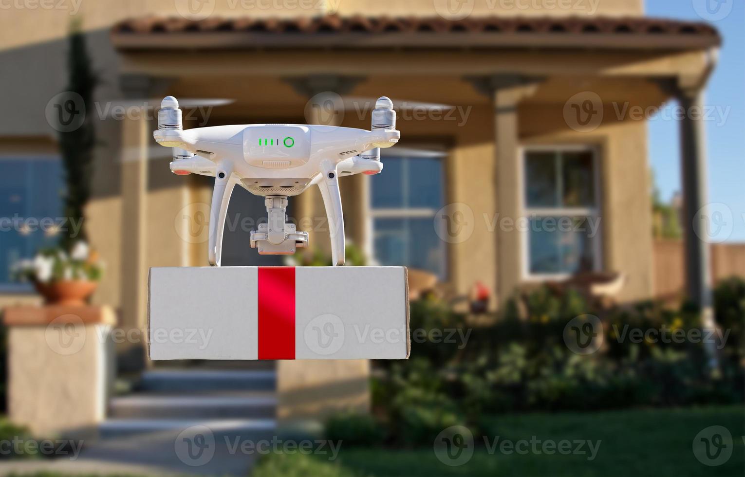 Unmanned Aircraft System UAV Quadcopter Drone Delivering Box With Red Ribbon To Home photo