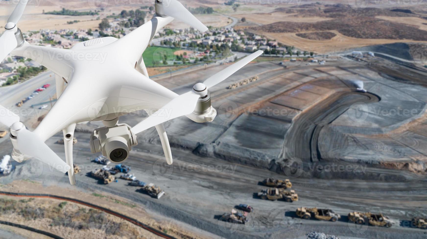 Unmanned Aircraft System Quadcopter Drone In The Air Over Construction Site. photo